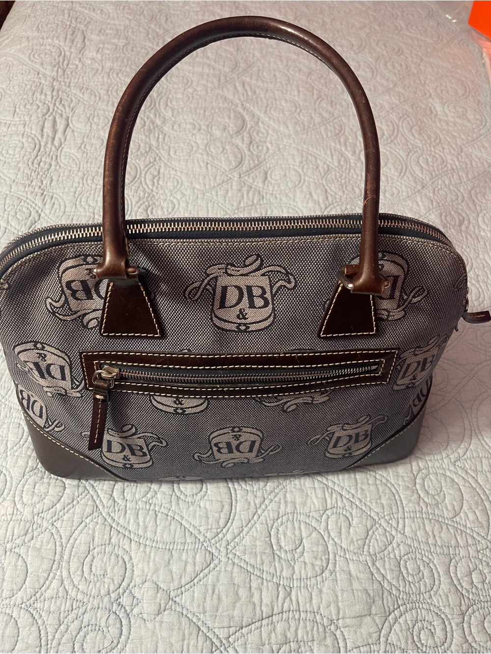 Dooney and Bourke Monogram Denim Donegal Dome Satchel with brown leather trim.